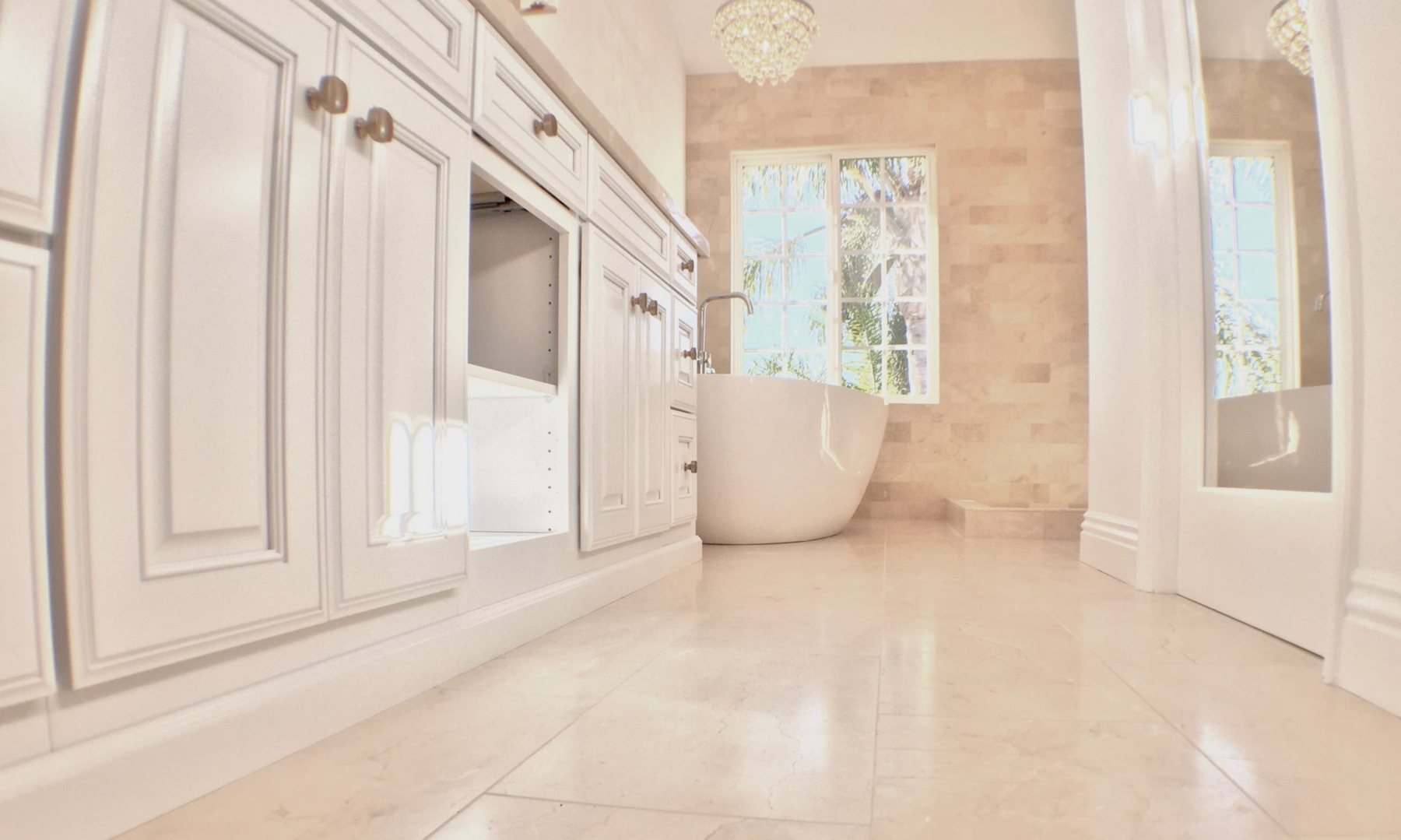 Blackbird Construction bathroom with custom cabinetry, stone surfaces, and a freestanding bathtub